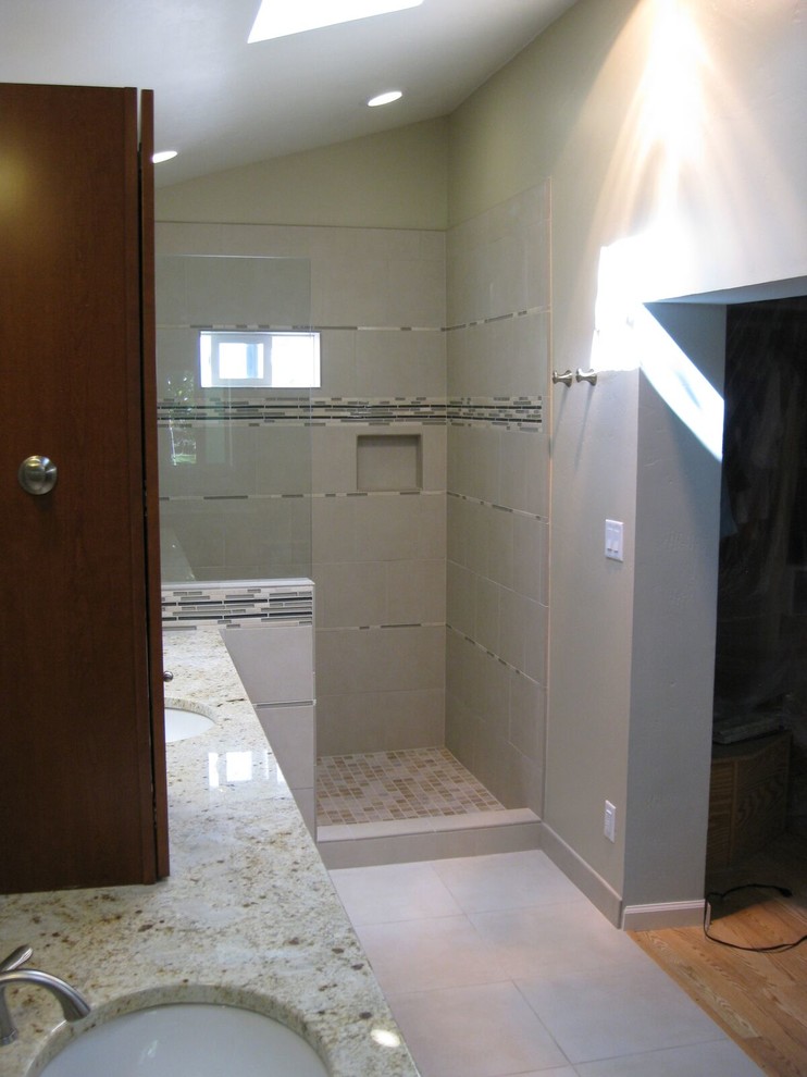 This is an example of a mid-sized traditional bathroom in Other with medium wood cabinets, an open shower, beige tile, porcelain tile, beige walls, porcelain floors, with a sauna, an undermount sink and granite benchtops.