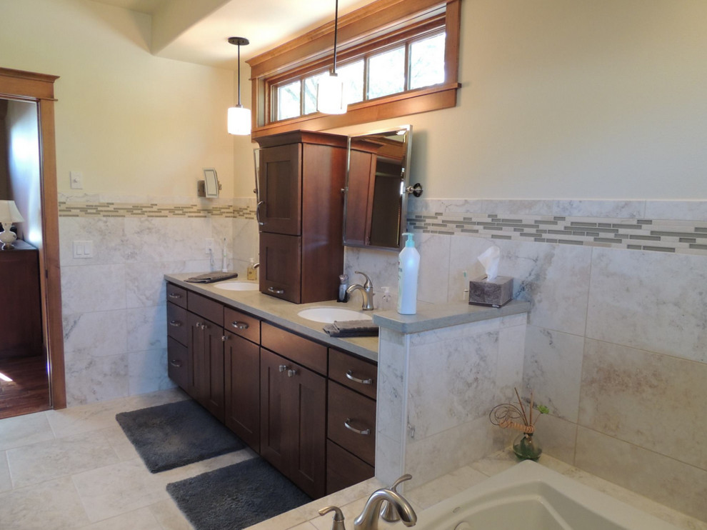 Inspiration for a mid-sized transitional master beige tile and stone tile travertine floor and beige floor drop-in bathtub remodel with shaker cabinets, brown cabinets, white walls and quartz countertops