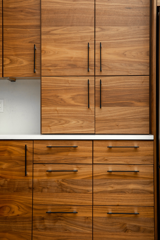 Inspiration for a small midcentury l-shaped open plan kitchen in Portland with flat-panel cabinets, medium wood cabinets, quartz benchtops, white splashback, engineered quartz splashback and white benchtop.