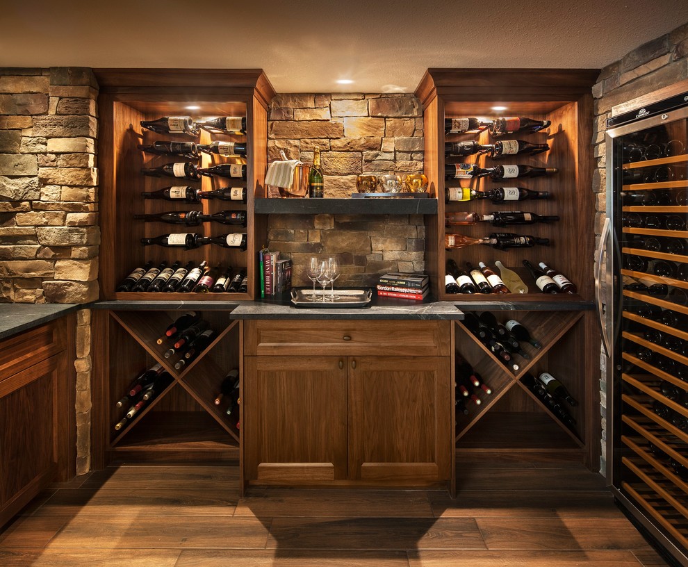 Mid-sized transitional brown floor and ceramic tile wine cellar photo in Calgary with storage racks