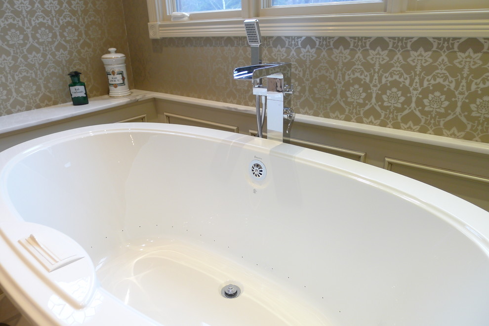 Example of a transitional beige tile and porcelain tile bathroom design in Indianapolis with a drop-in sink, furniture-like cabinets, beige cabinets, marble countertops and a one-piece toilet