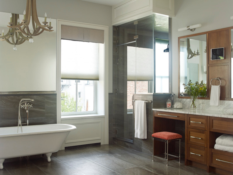 Design ideas for an expansive transitional master bathroom in New York with recessed-panel cabinets, medium wood cabinets, a claw-foot tub, a double shower, ceramic floors, a console sink, marble benchtops and white walls.