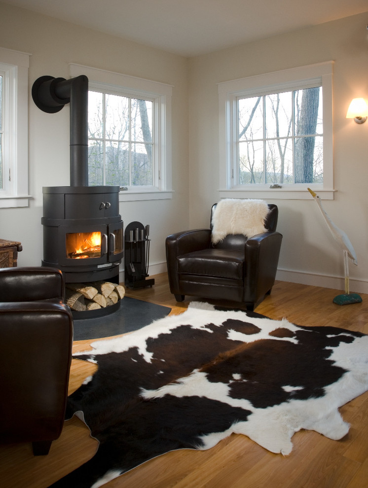 Mid-sized transitional open concept living room in Portland Maine with medium hardwood floors and a wood stove.