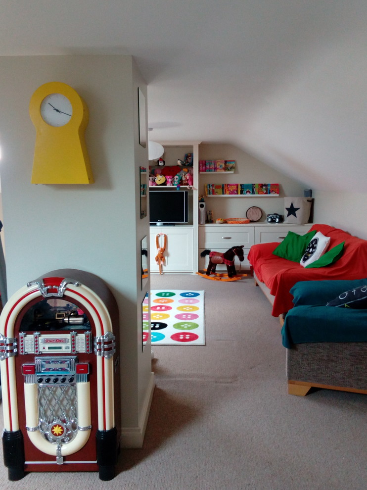 This is an example of a mid-sized transitional gender-neutral kids' playroom for kids 4-10 years old in Other with beige walls, carpet and beige floor.