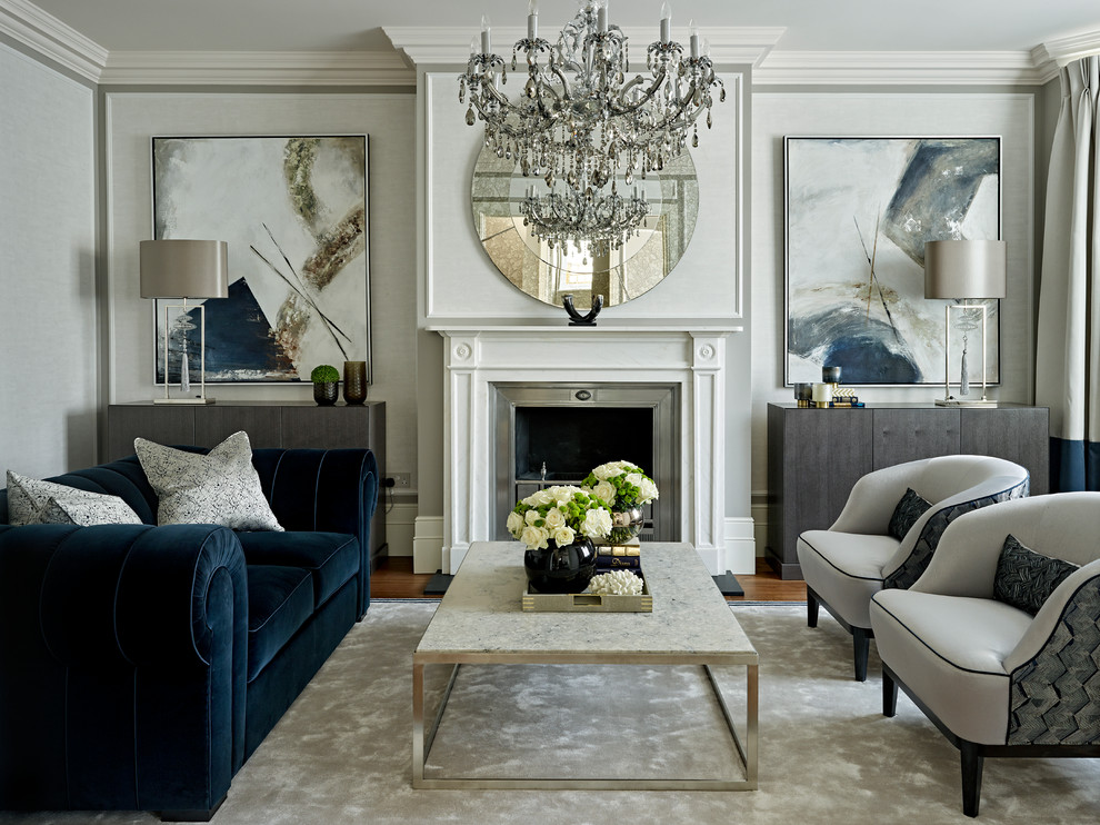 Inspiration for a transitional formal enclosed living room in London with no tv, a standard fireplace and grey walls.