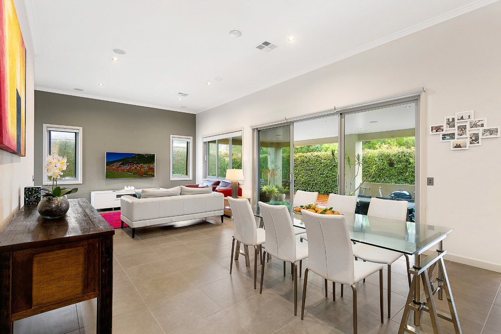 Large contemporary open plan dining in Sydney with brown walls, brown floor, ceramic floors and no fireplace.