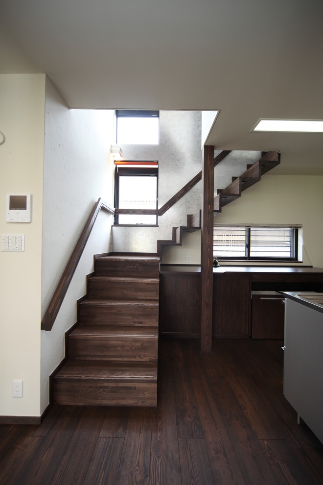 This is an example of a mid-sized asian wood floating staircase in Other with wood risers and wood railing.