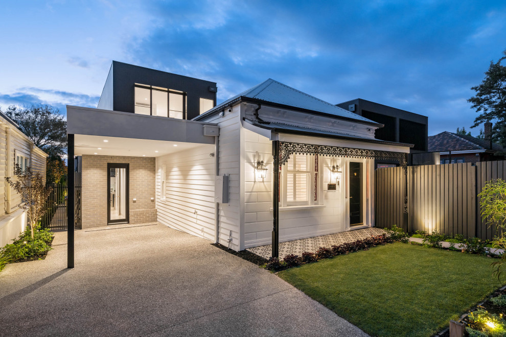 Design ideas for a large contemporary two-storey white house exterior in Melbourne with wood siding, a flat roof, a metal roof and board and batten siding.