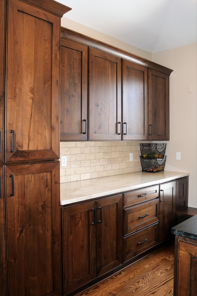 Mid-sized transitional l-shaped medium tone wood floor and brown floor open concept kitchen photo in Denver with recessed-panel cabinets, medium tone wood cabinets, granite countertops, beige backsplash, stone tile backsplash, stainless steel appliances, two islands and multicolored countertops