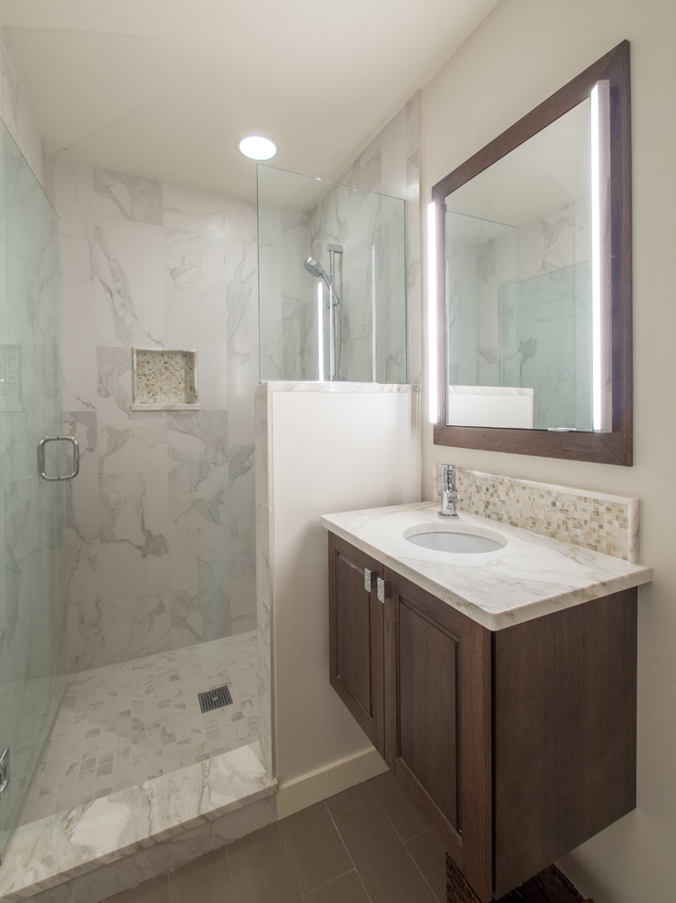 Design ideas for a small contemporary 3/4 bathroom in Seattle with furniture-like cabinets, medium wood cabinets, an alcove shower, a two-piece toilet, gray tile, porcelain tile, white walls, porcelain floors, an undermount sink, marble benchtops, brown floor, a hinged shower door, white benchtops, a single vanity and a floating vanity.
