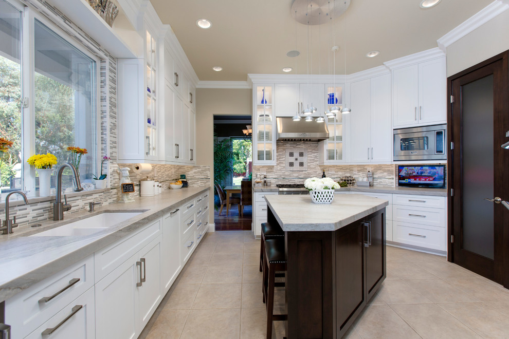 Mid-sized transitional u-shaped porcelain tile enclosed kitchen photo in San Diego with an undermount sink, recessed-panel cabinets, white cabinets, quartzite countertops, gray backsplash, stainless steel appliances, an island and matchstick tile backsplash