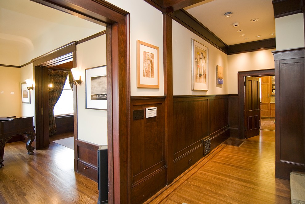 Photo of a large arts and crafts hallway in San Francisco with beige walls, light hardwood floors and brown floor.