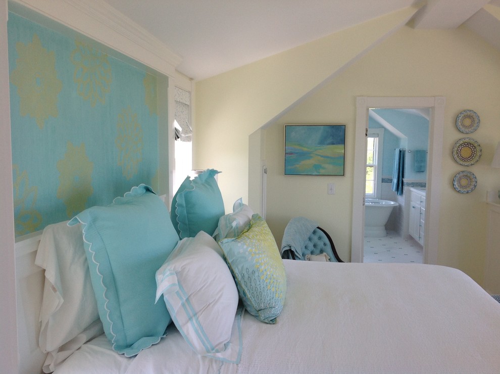 Photo of a large beach style master bedroom in Boston with yellow walls and no fireplace.