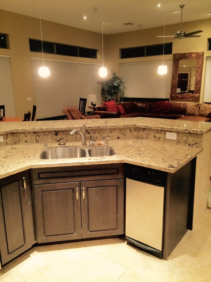 Kitchen - large transitional l-shaped ceramic tile and beige floor kitchen idea in Phoenix with a double-bowl sink, raised-panel cabinets, dark wood cabinets, granite countertops, multicolored backsplash, stone slab backsplash, stainless steel appliances and an island