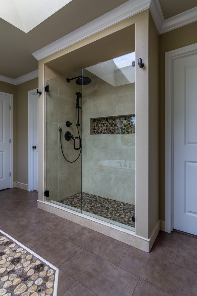 Large modern master bathroom in Seattle with an undermount sink, recessed-panel cabinets, medium wood cabinets, marble benchtops, a drop-in tub, an open shower, a one-piece toilet, multi-coloured tile, pebble tile, beige walls and porcelain floors.