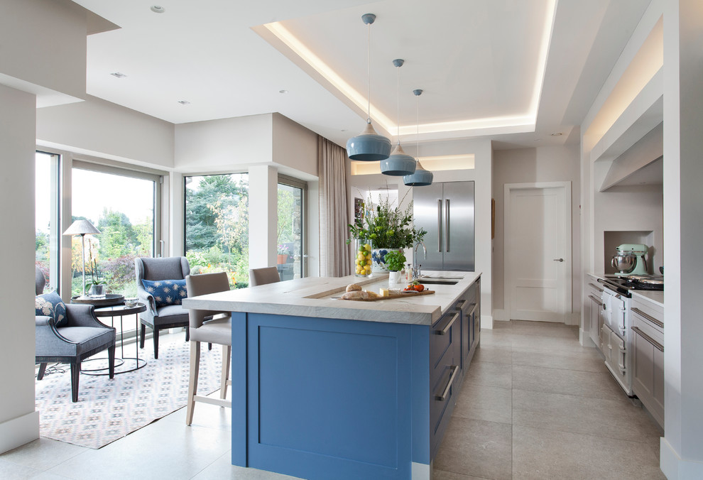 Contemporary galley separate kitchen in Belfast with shaker cabinets, blue cabinets, stainless steel appliances, with island and grey floor.