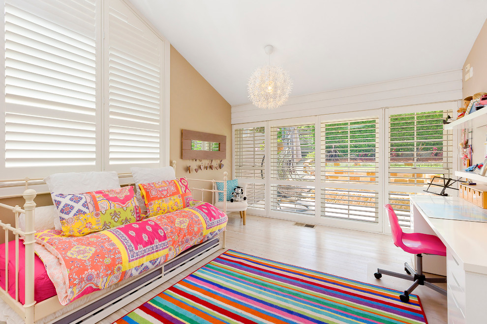 Large contemporary kids' bedroom in Sydney with beige walls and light hardwood floors for kids 4-10 years old and girls.
