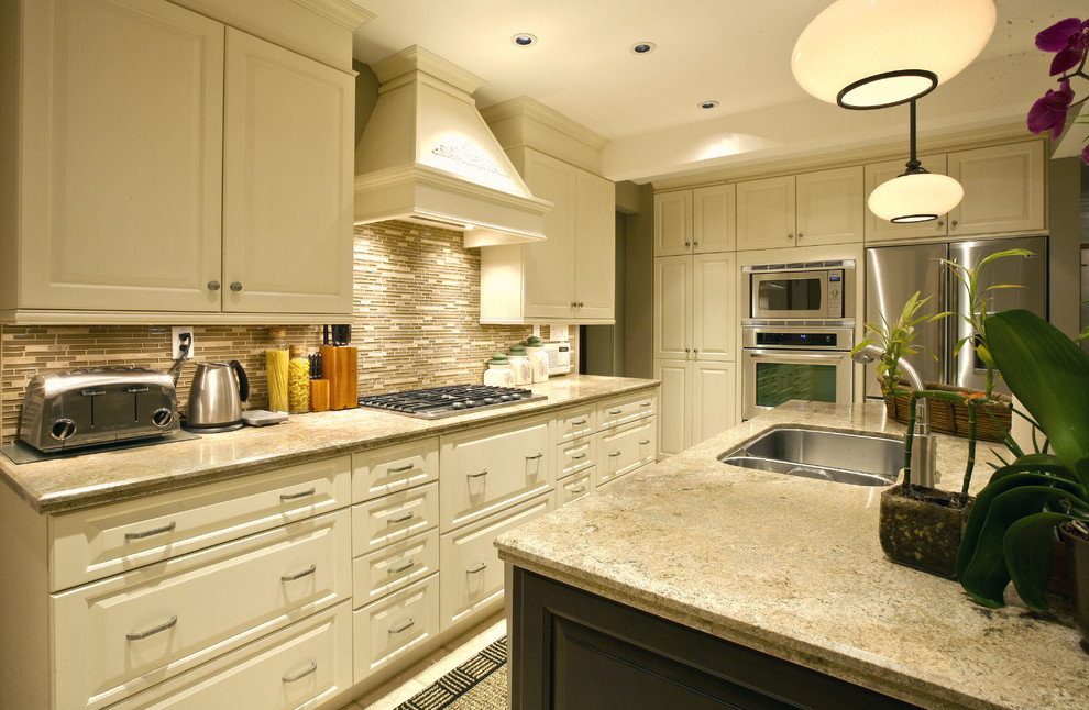 Inspiration for a large transitional u-shaped kitchen pantry remodel in Toronto with a double-bowl sink, raised-panel cabinets, white cabinets, granite countertops, multicolored backsplash, matchstick tile backsplash, stainless steel appliances and an island