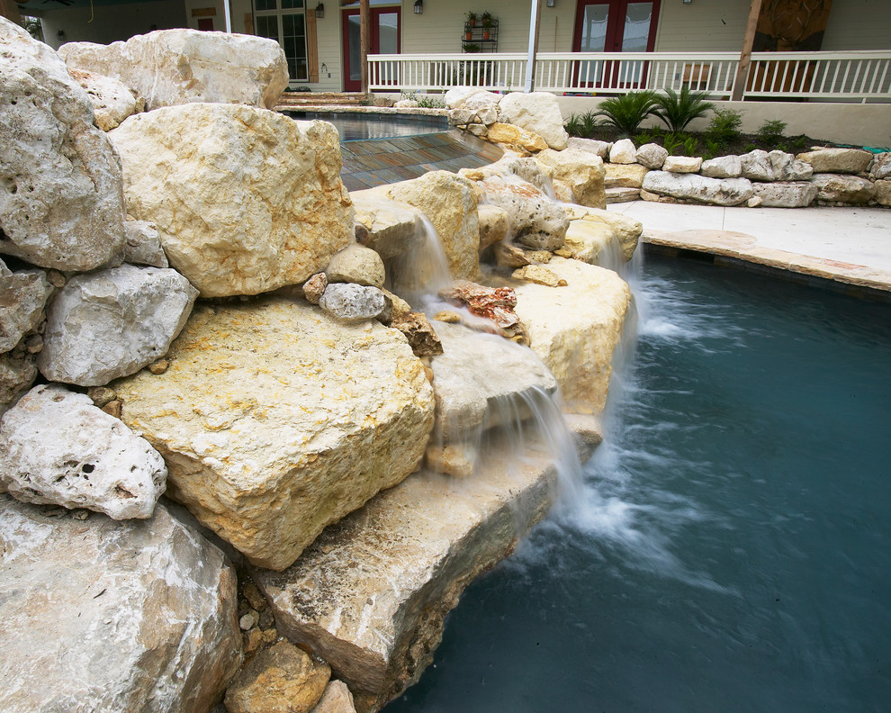 Large mountain style courtyard concrete and custom-shaped natural pool fountain photo in Austin