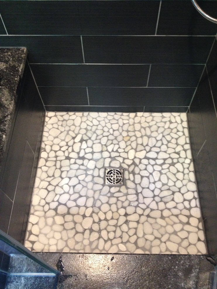 Design ideas for a small modern master bathroom in Chicago with an alcove shower, black walls, pebble tile floors, beige tile, black tile and pebble tile.
