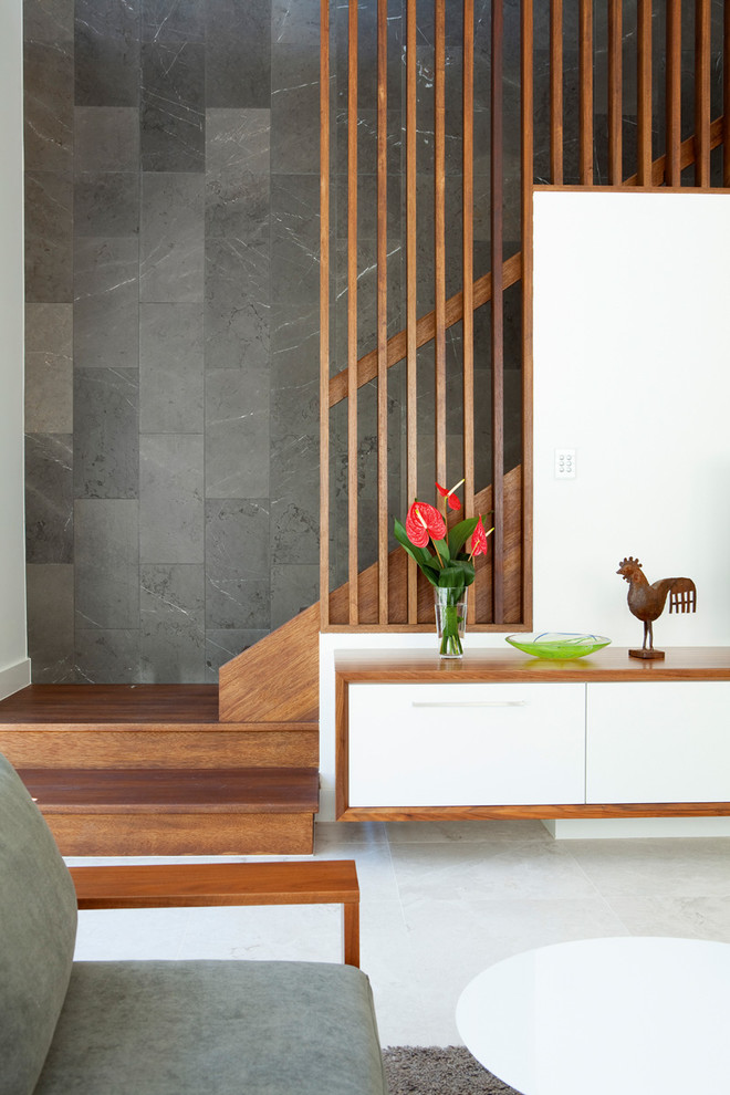 This is an example of a mid-sized contemporary wood staircase in Brisbane with wood risers.