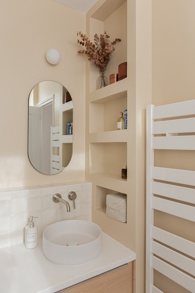 Small classic shower room bathroom in Paris with recessed-panel cabinets, light wood cabinets, a built-in shower, white tiles, porcelain tiles, beige walls, ceramic flooring, a built-in sink, a hinged door, white worktops, a wall niche, double sinks and a floating vanity unit.