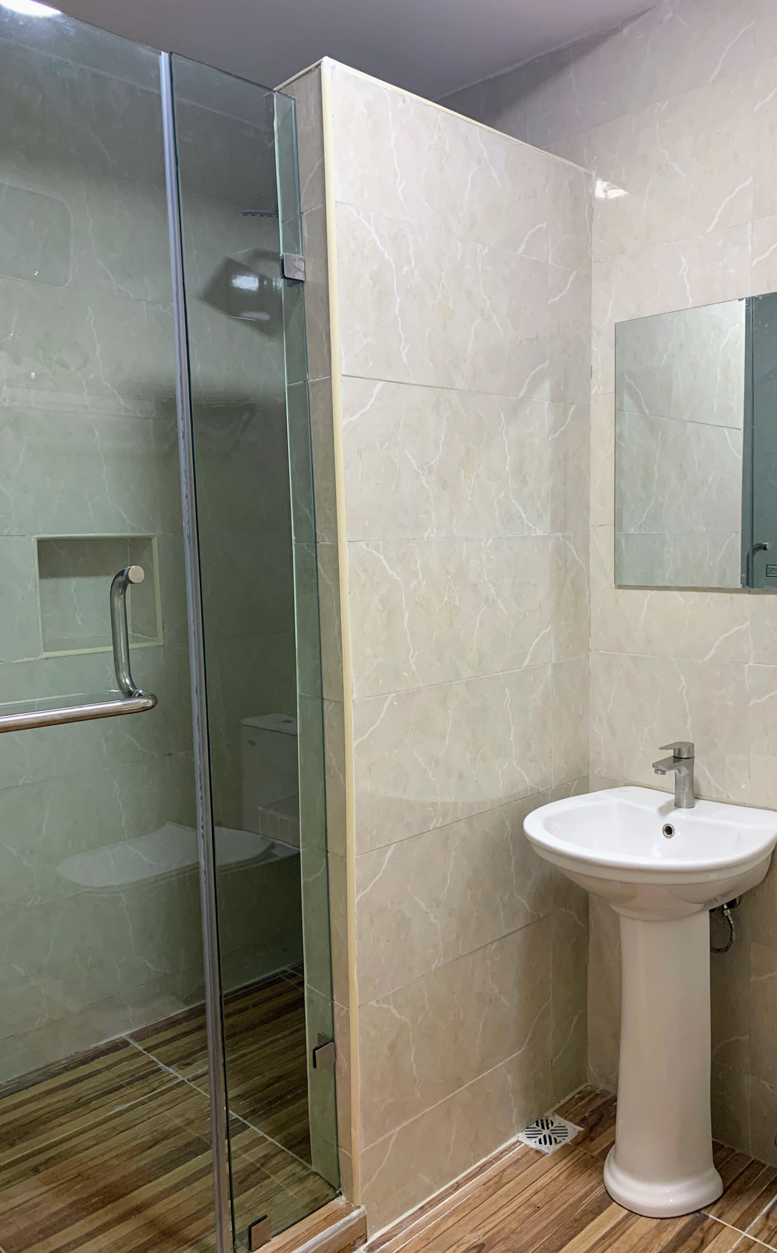 Bathroom shower room with laminate effect floor tiles