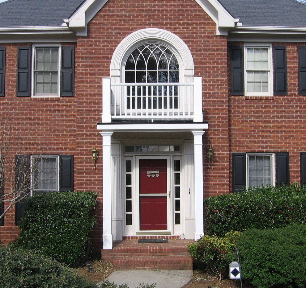 This is an example of a mid-sized traditional front door in Atlanta with a single front door and a red front door.