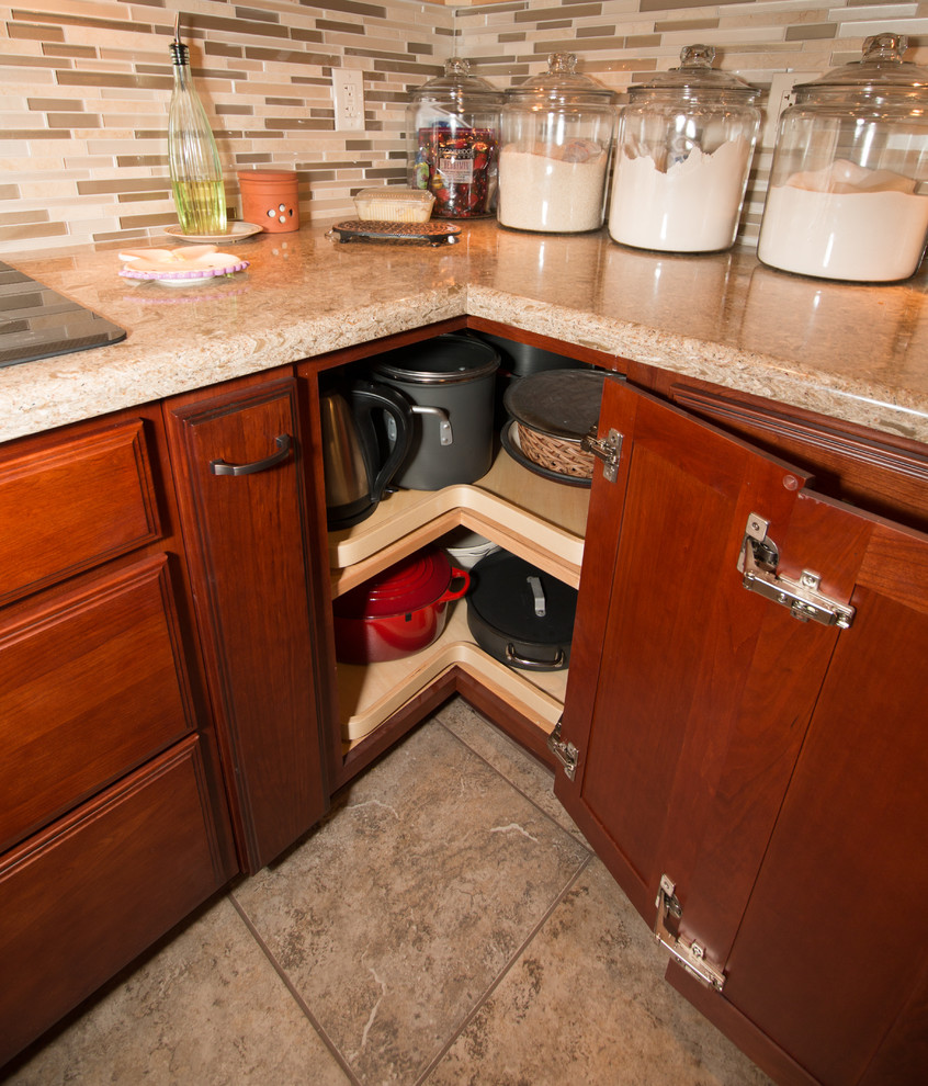 Kitchen - large transitional u-shaped porcelain tile kitchen idea with an undermount sink, flat-panel cabinets, medium tone wood cabinets, quartz countertops, beige backsplash, mosaic tile backsplash, stainless steel appliances and an island