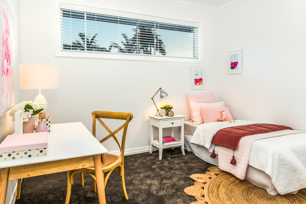 This is an example of a beach style kids' room for girls in Townsville with white walls, carpet and black floor.