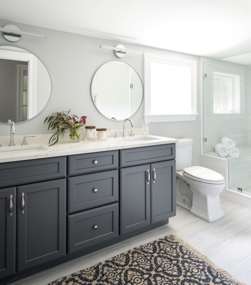 Elegant master gray tile ceramic tile, white floor, double-sink and vaulted ceiling shower bench photo in Boston with shaker cabinets, blue cabinets, a two-piece toilet, gray walls, an undermount sink, quartz countertops, white countertops and a built-in vanity