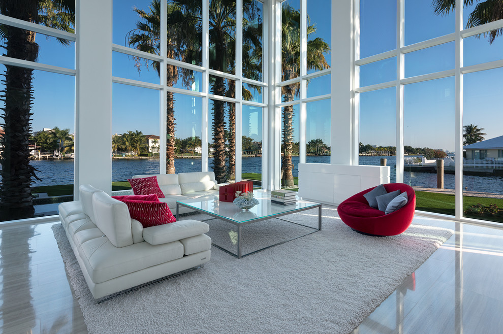 Large contemporary open concept living room in Miami with white walls.