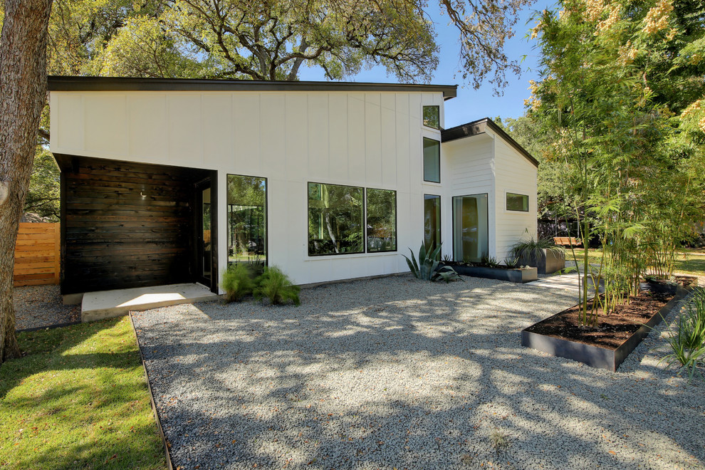 Contemporary white exterior in Austin with a shed roof.
