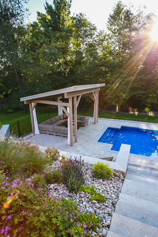 Design ideas for a large modern backyard patio in Toronto with a gazebo/cabana, a fire feature and concrete pavers.