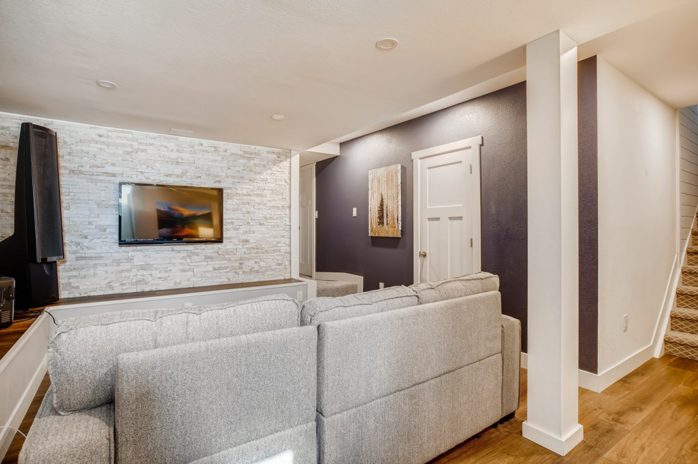 This is an example of a small classic fully buried basement in Denver with a home cinema, purple walls and a feature wall.