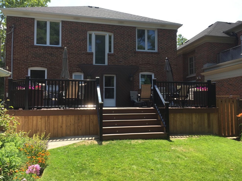 Large transitional backyard deck photo in Toronto with no cover