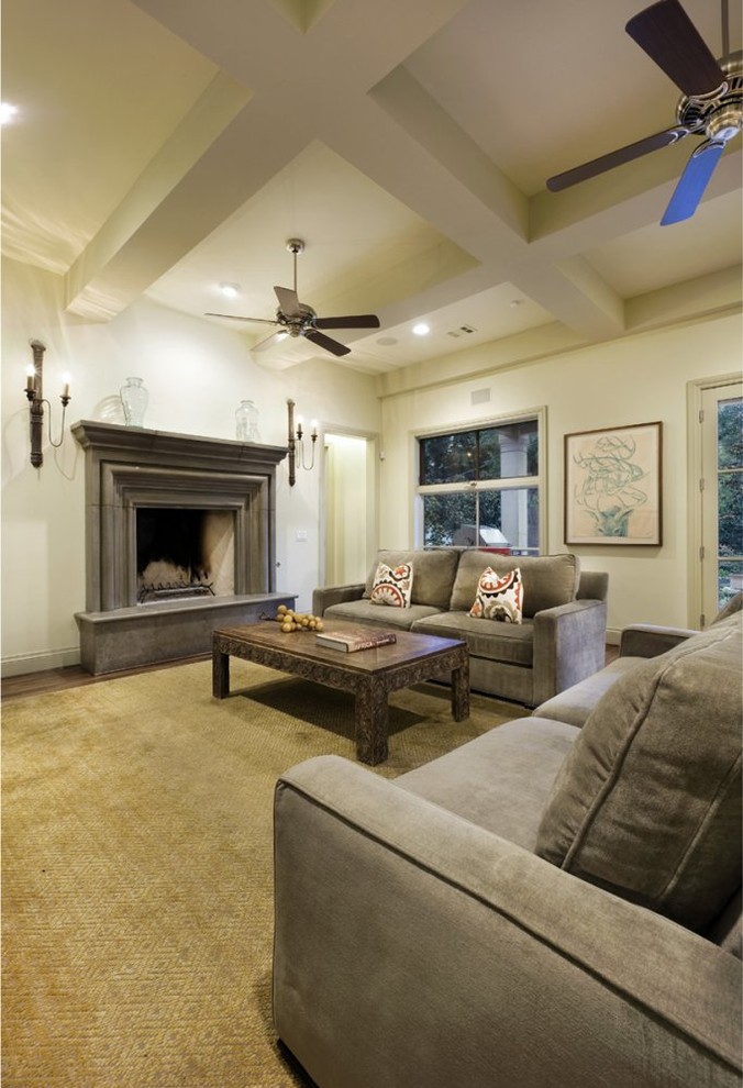 This is an example of a traditional family room in Austin with beige walls, a standard fireplace and a stone fireplace surround.