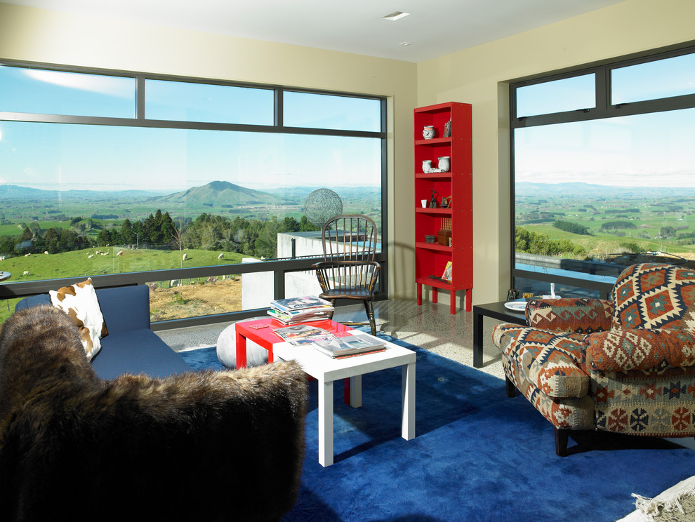 Large contemporary Open Concept living room in Hamilton With a Library, Beige Walls, Concrete Floors, a Standard Fireplace, a Metal Fireplace Surround and Multi-Coloured Floor.