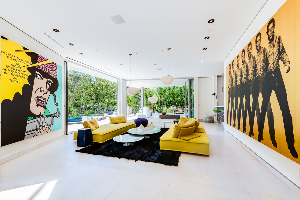 This is an example of an expansive contemporary open concept living room in Los Angeles with a home bar, white walls and grey floor.