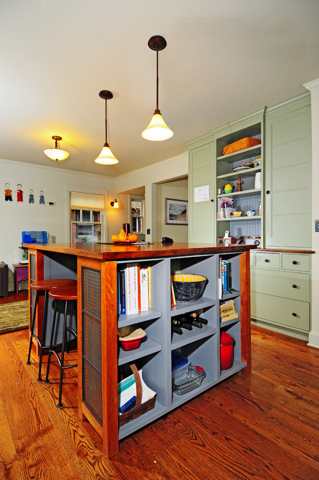 Mid-sized transitional u-shaped dark wood floor kitchen pantry photo in Seattle with a farmhouse sink, shaker cabinets, green cabinets, wood countertops, green backsplash, stone tile backsplash, stainless steel appliances, gray walls and an island