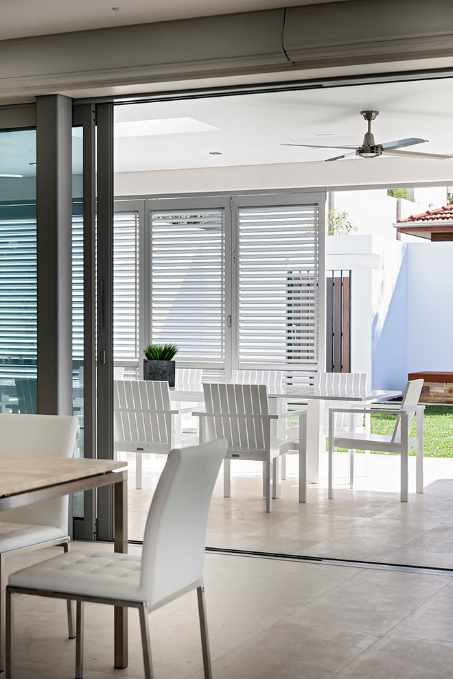 This is an example of a mid-sized modern kitchen/dining combo in Perth with limestone floors.