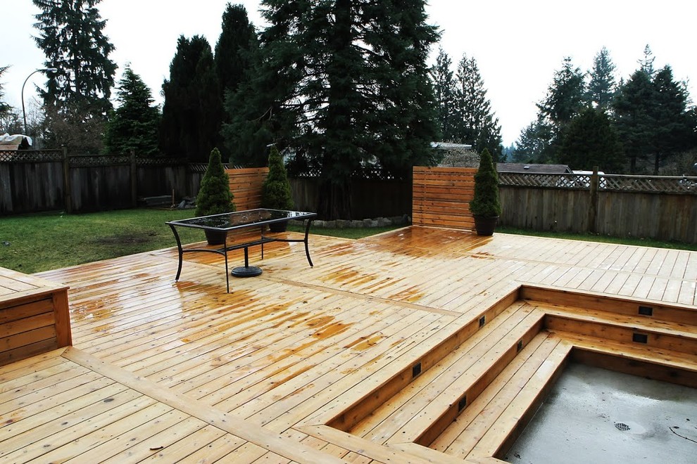 Large mountain style backyard water fountain deck photo in Vancouver with no cover