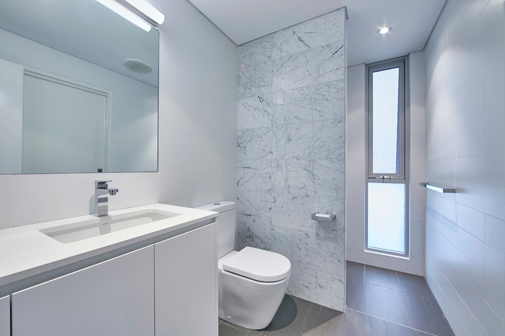 Inspiration for a mid-sized contemporary 3/4 bathroom in Perth with flat-panel cabinets, white cabinets, a curbless shower, black and white tile, marble, white walls, an undermount sink, engineered quartz benchtops and an open shower.