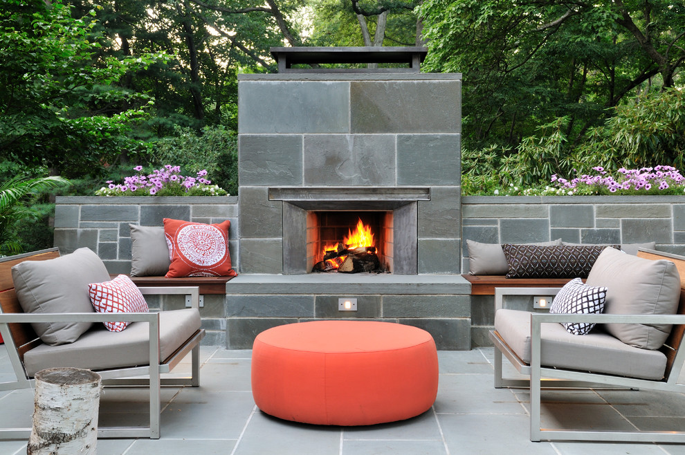 Mid-sized midcentury backyard patio in Boston with a fire feature, natural stone pavers and no cover.