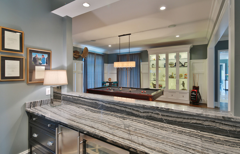 Photo of a transitional wet bar in Raleigh with an undermount sink, recessed-panel cabinets, dark wood cabinets, granite benchtops and medium hardwood floors.