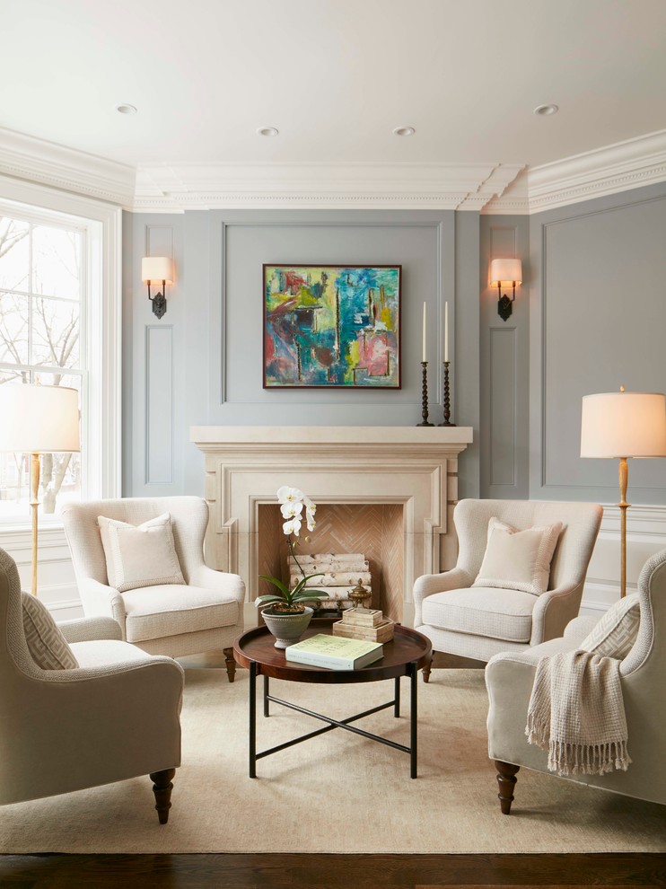 Inspiration for a traditional living room in Chicago with grey walls, a standard fireplace, medium hardwood floors and a stone fireplace surround.