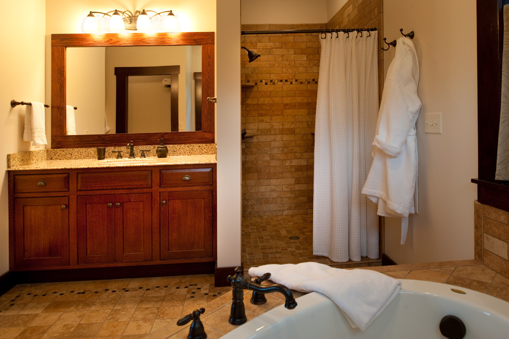 This is an example of a traditional bathroom in Minneapolis with an integrated sink, shaker cabinets, medium wood cabinets, granite benchtops, an open shower, beige tile and beige walls.