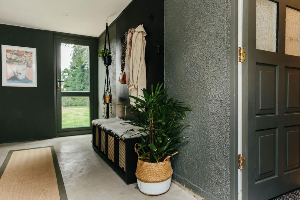 Photo of a large midcentury mudroom in Hampshire with green walls.