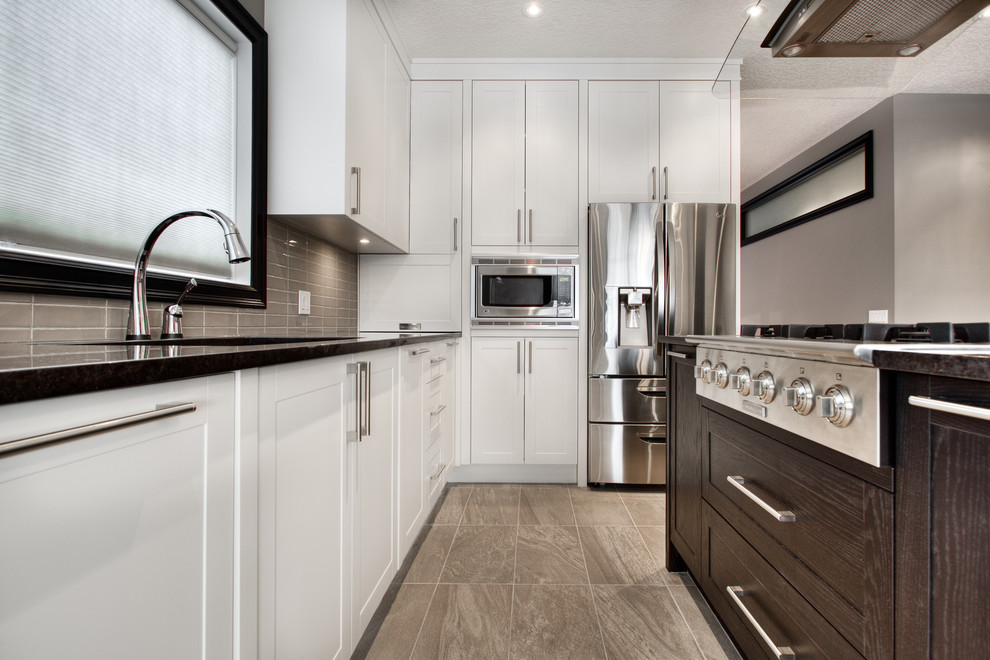 Example of a transitional kitchen design in Calgary
