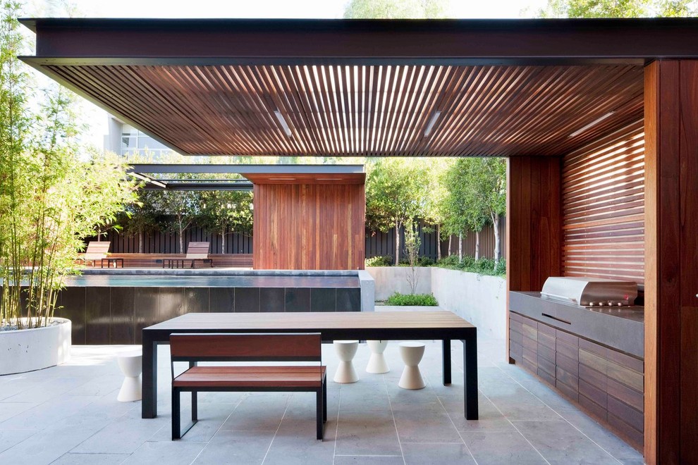 Photo of a large contemporary backyard patio in Melbourne with concrete pavers.
